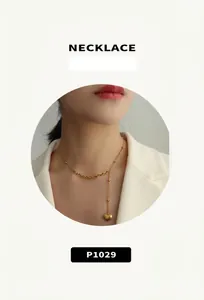 Detail of 18K gold plated heart necklace with beaded chain and Y-shape pendant