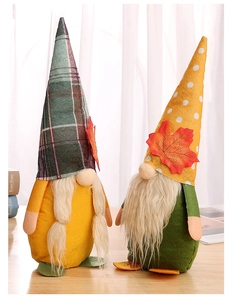 Detail of harvest gnomes with maple leaf decorations on a rustic wooden table