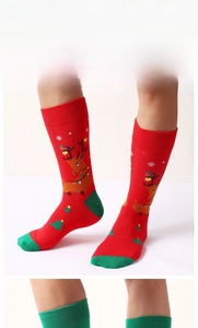 Detailed view of red Christmas crew socks featuring reindeer patterns and green solid styles