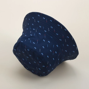 Detail of dark blue reversible bucket hat with red and white geometric patterns