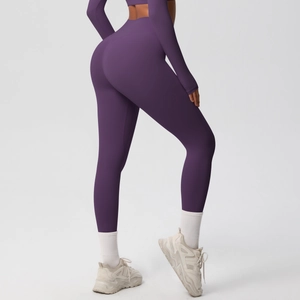 Detail of high-waist purple yoga leggings with seamless sculpting and breathable fabric