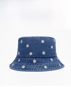 Side view of dark blue denim bucket hat with white daisy embroidery and precise stitching