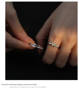 Macro detail of silver butterfly ring with polished finish and luminous enamel inlay