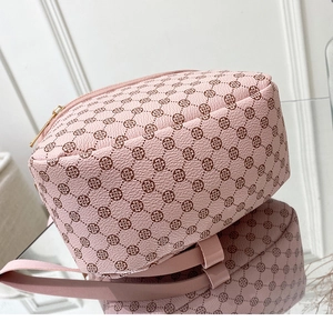 Detail shot of the pink PU leather mini backpack showing the bottom and side heart textures
