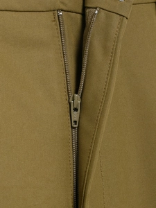 Close-up of a high-quality metal zipper and khaki twill cotton fabric on workwear shorts