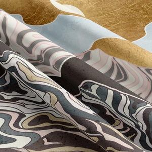 Detailed close-up of soft tapestry fabric with gold and marble wave texture