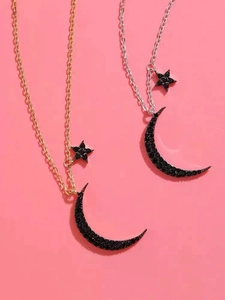 Close-up of gold and silver moon star necklaces featuring inlaid black cubic zirconia gems