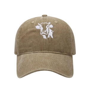 Detailed close-up of cow embroidery on vintage washed cotton baseball cap