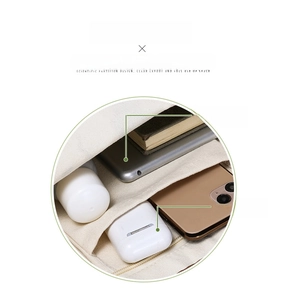 Detailed internal view of canvas tote bag with compartments for tablet and accessories