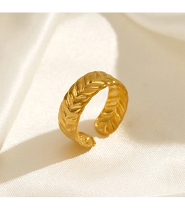 Macro detail of golden stainless steel adjustable ring with wheat ear texture