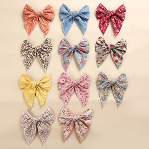 Selection of eleven cotton bow hair clips with diverse floral and leopard print patterns