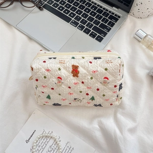Close-up of quilted cosmetic bag with cute Christmas bear and snowman patterns
