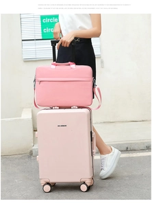 Pink laptop bag attached to matching rolling suitcase handle for convenient travel use