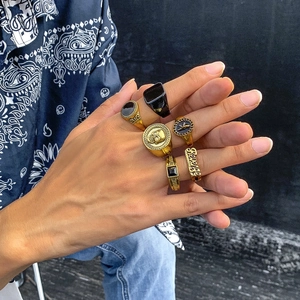 Detailed close-up of six-piece vintage alloy rings set on a model hand with street style