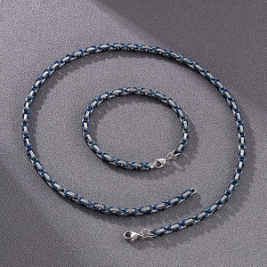 Macro detail of silver and deep blue Byzantine link chain necklace and bracelet set