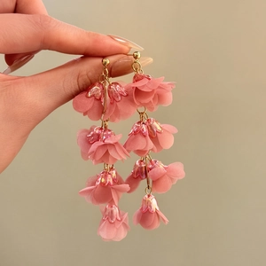 Detailed view of pink lily of the valley tassel earrings with soft chiffon petals