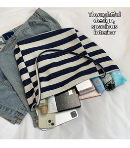 Spacious interior of blue and white striped canvas tote bag showing daily essentials