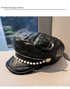 Detail of black quilted leather baker boy hat with gold chain and pearl strap decor