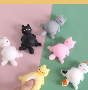 Close-up of soft cat squishy toys showing elastic texture and various cute designs