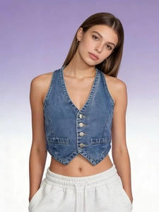 Close-up of vintage dark blue denim vest with metal buttons and V-neckline detail