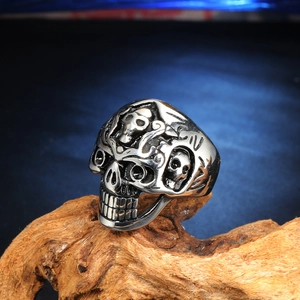Detailed view of punk skull ring with vintage black oxidation on a wooden base