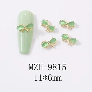 Detail of 11x6mm mint green cat-eye butterfly nail art charm with gold metal frame
