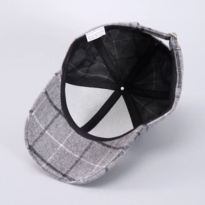Detail view of the interior lining and adjustable metal buckle on houndstooth baseball cap