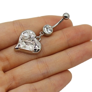Detail of silver heart belly button ring with clear zircon and small white pearl inlay