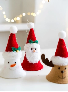 Detailed view of handmade Christmas felt bell ornaments featuring Santa, snowman and elk