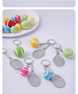 Detailed view of colorful mini tennis ball and racket keychains in vibrant colors