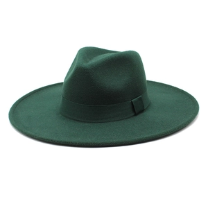 Detail of dark green wool felt fedora hat featuring a matching decorative ribbon band