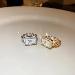 Gold and silver plated watch link rings with rectangle mother of pearl face and zirconias