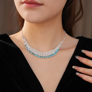 Close-up of multi-layer fringe necklace with turquoise stones and sparkling rhinestones
