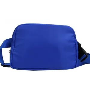 Detail view of a blue nylon waist bag showing the plastic buckle and woven shoulder strap