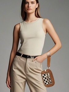 Detail of brown and checkered wristlet pouch with metal zipper and lanyard strap