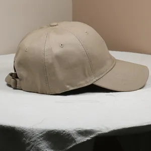 Side view of khaki cotton twill baseball cap with adjustable metal buckle strap