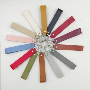 Close-up of colorful leather wristlet keychains with metallic rings in 14 various shades
