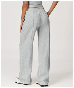 Close-up of high-waisted grey sweatpants with front seam detail and elastic waistband