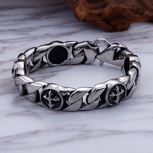 Men's retro stainless steel cross and skull chain bracelet on marble surface