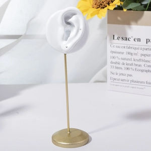 Creative ear-shaped jewelry display stand with golden rod and stable round base
