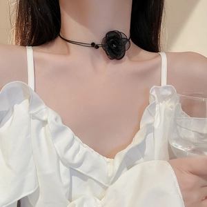 Close-up of a double-layered black lace floral choker with crystal beads on a model