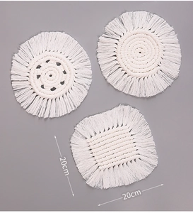 Detailed overhead shot of 20cm woven cotton coasters with white tassels in Nordic style