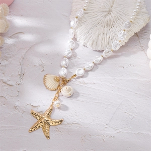 Detailed close-up of multilayer summer necklace with starfish charms and baroque pearls