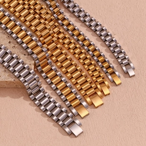 Detailed macro view of multi-color 18K gold plated stainless steel watch band bracelets
