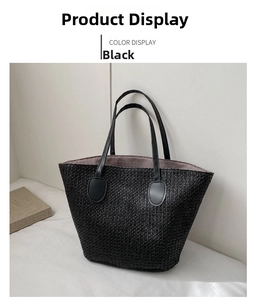 Detail of black woven straw tote bag with leather handles on a minimalist background
