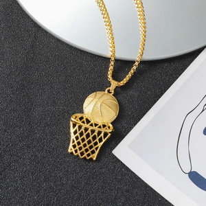 Hip hop style gold basketball hoop pendant necklace on a textured black surface