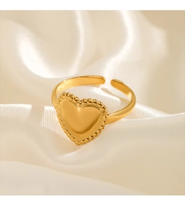 Macro view of adjustable 18K gold plated heart ring with delicate beaded edge texture