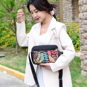 Lightweight printed oxford crossbody bag with colorful leaves pattern and adjustable strap