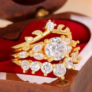 Detailed close-up of a golden diamond ring set resting in a luxury red velvet jewelry box