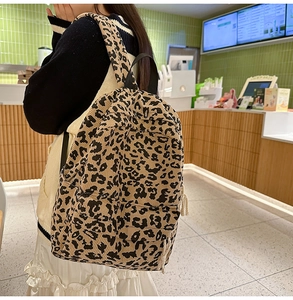 Detailed close-up of leopard print corduroy texture on a casual woman backpack